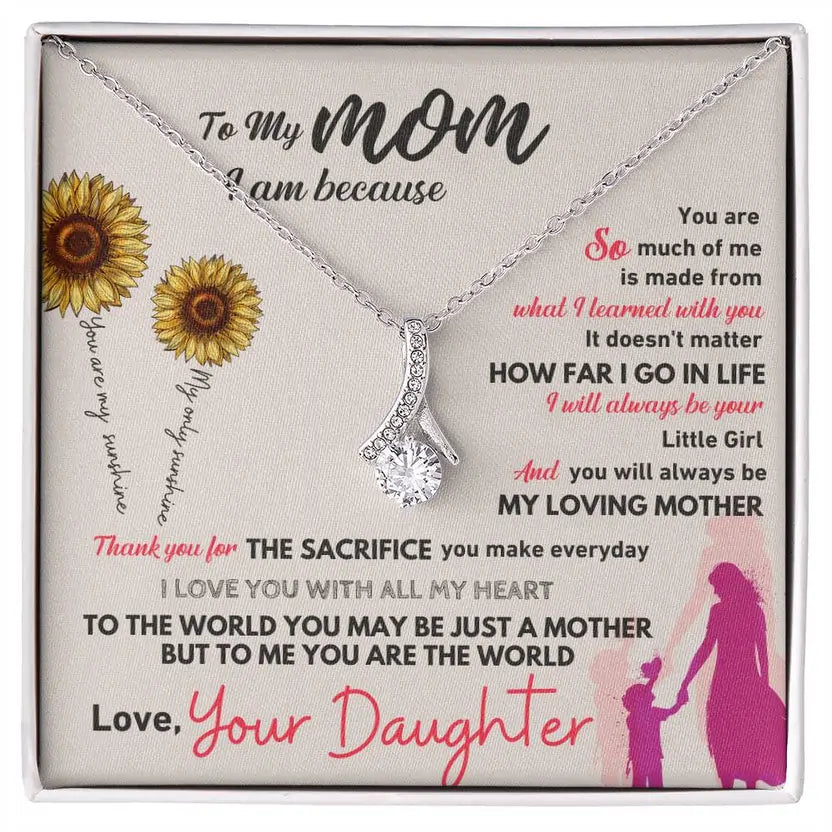 Necklace in a box with a sentimental message to a mother from her daughter, featuring sunflowers and a silhouette of a mother and child.