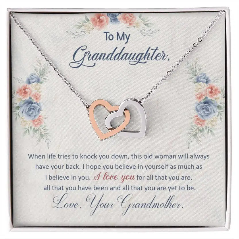 Necklace with interlocking hearts on a floral card with text, displayed in a box.